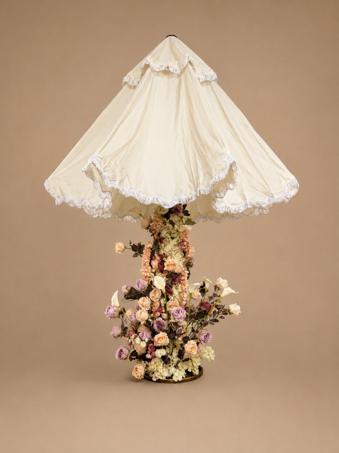 Custom floral parasol install — ivory ruffled canopy over a column of peach, mauve and cream faux blooms