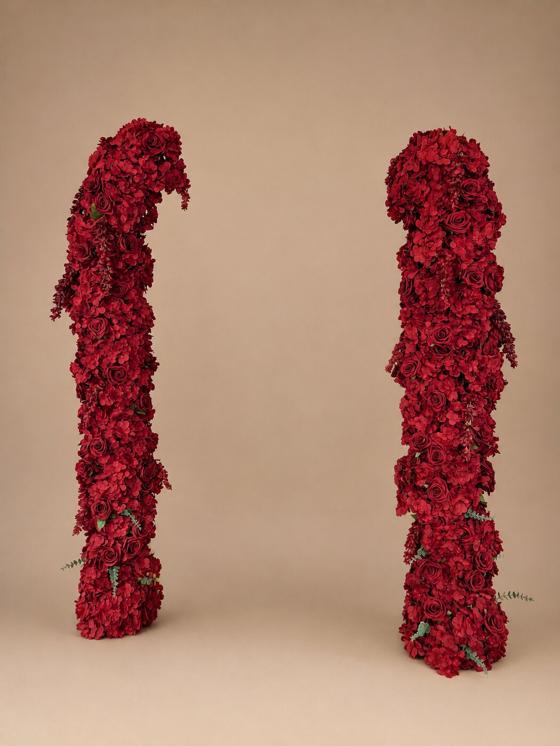Pair of custom deep red rose and hydrangea arch columns with trailing eucalyptus