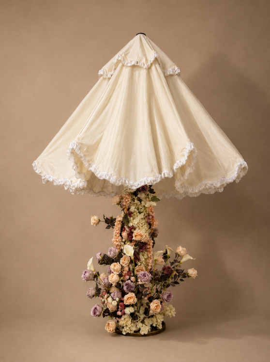 Custom floral parasol with a ruffled ivory canopy and a flower-covered base in peach, mauve, burgundy, and cream